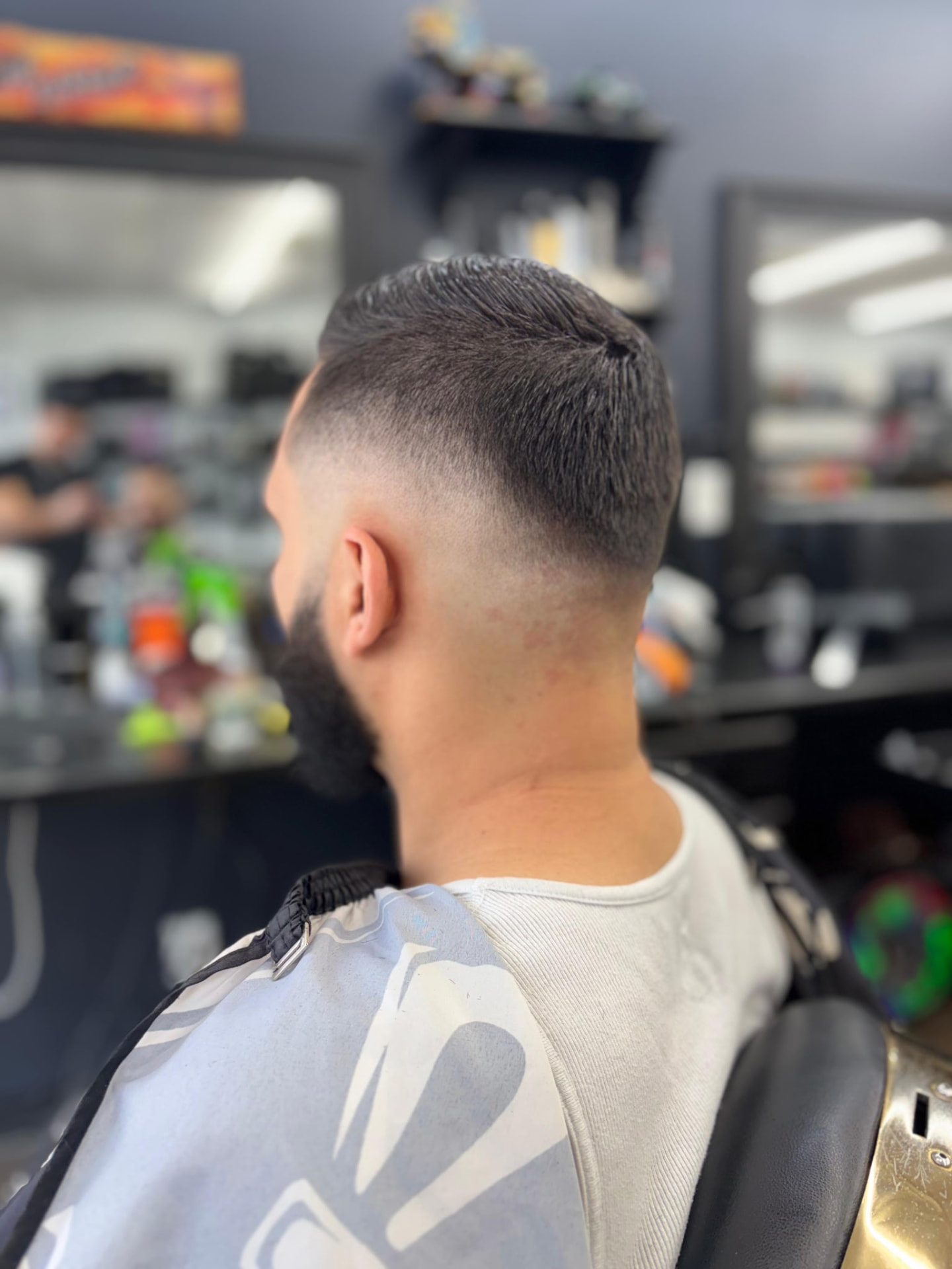 Clean fade and styled haircut finished in Ivan's barber chair